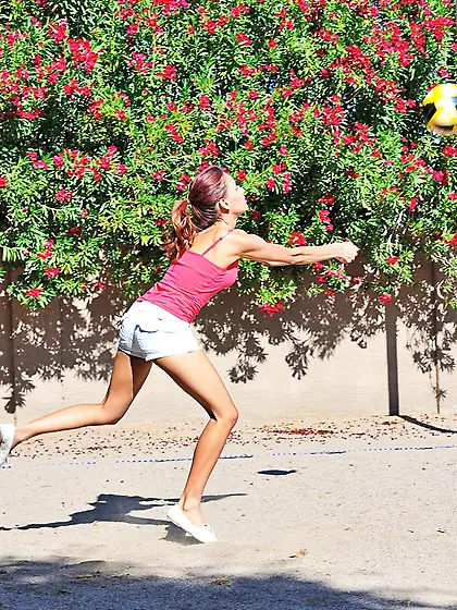 Thin brunette plays volleyball
