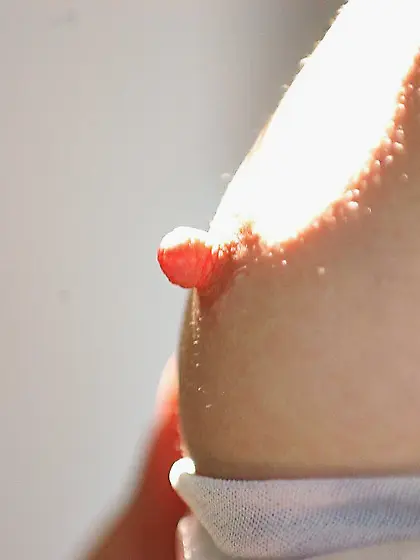 Frizzy-haired brunette shows her suckable nips in a kinky solo g