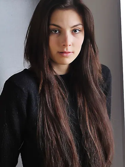 Dark-haired beauty in leather pants shows her stunning natural b