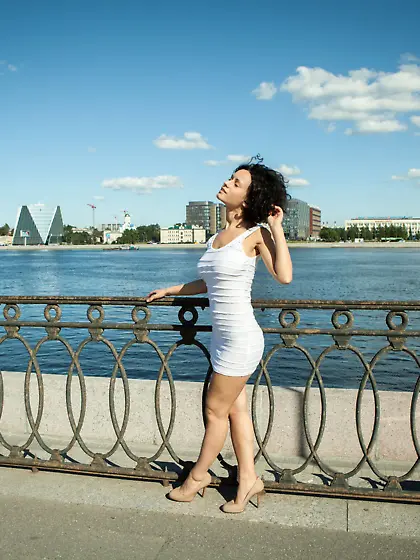 Curly-haired chick with a really hairy pussy gets naked on a sof