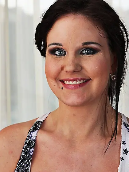 Slightly awkward brunette with a great tan showing off her goodi