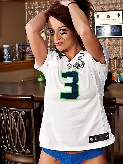 Busty football fan Nikki Sims teases in a jersey and panties in