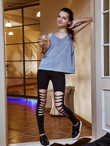 Ripped pants brunette exposing her slender naked body on camera