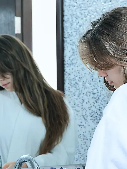 Brunette with long legs posing all naked by the bathroom sink Vi