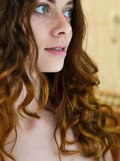 Timid-looking blue-eyed girl quickly strips naked in the bathroo