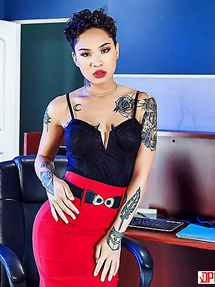 Asian brunette in a red skirt gets to suck cock in the office