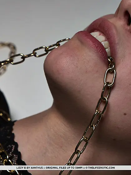 Sexy blonde bound in chains rubs her pussy...