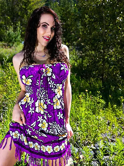 Very beautiful doll Katie Banks is in the meadow taking off dres