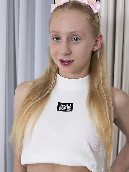 Alice Blue gets naked on a bed wearing cute bows in her hair