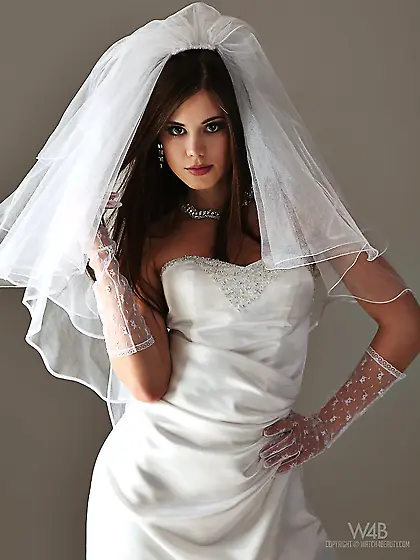 Licentious queen in sparkling wedding gown undressing and flaunt