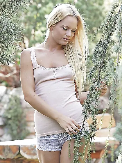 Towheaded babe undresses in the fresh air and masturbates on the