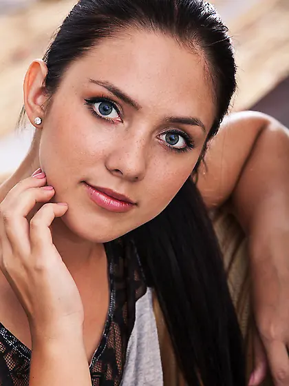 Dark-haired seductress with long slender legs fingering herself,