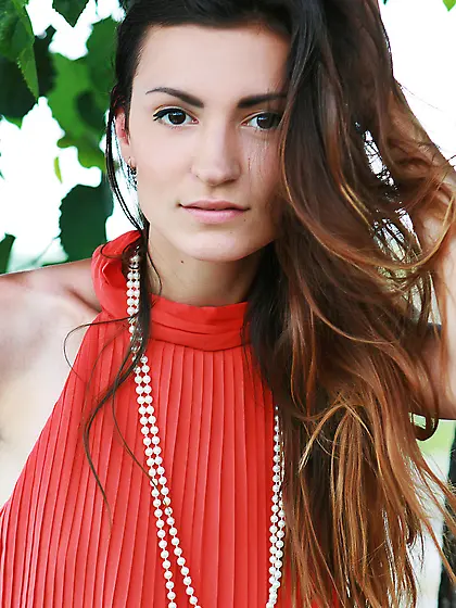 Brunette beauty takes off her red retro-style dress outdoors Vid