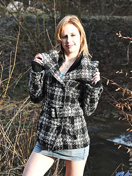 Teen girl Deina Nubiles in mini skirt and boots pulls down her p