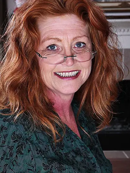 Mature redhead plays pink