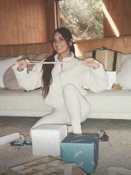 Olivia Munn in white outfit at a Christmas