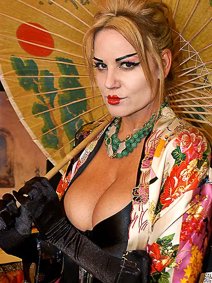 Busty blonde slut Kelly Madison with oriental makeup teases with