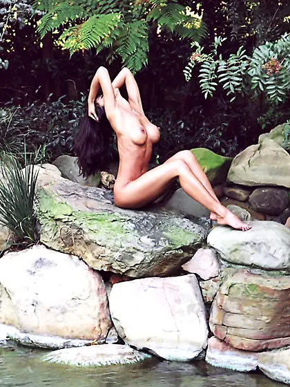 Linda O'Neil posing by the lake and shows her tits and her