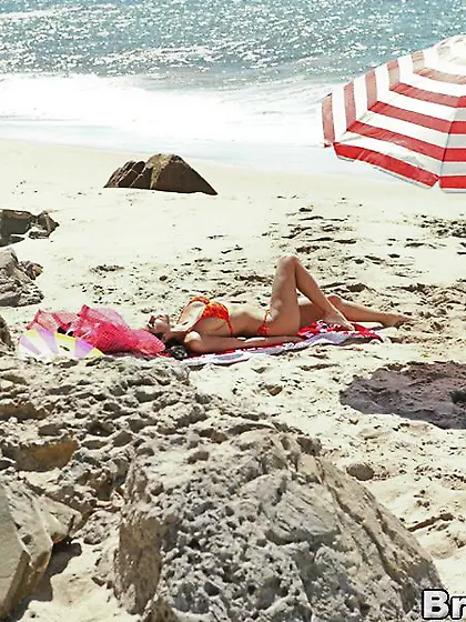 Brunette latina poses seaside