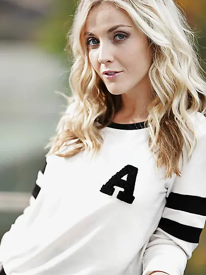 Blonde honey bares tits and poses in panties and stockings on th