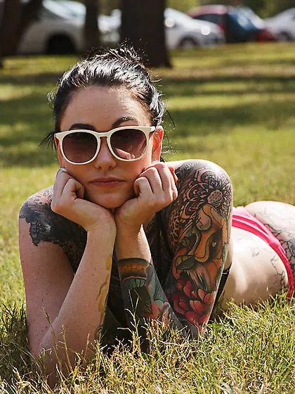 Leggy brunette with big tattoos goes nude...