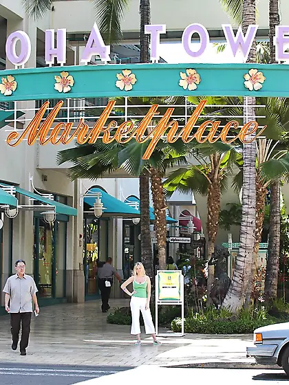 Alison Angel posing in her white pants and green shirt and shows