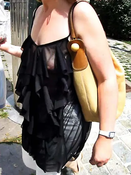 In a frilly black top on the street