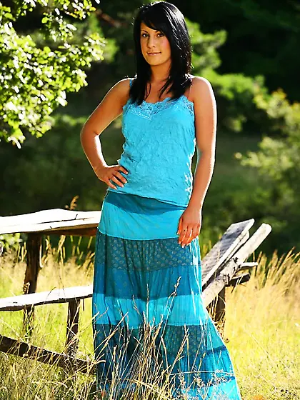 Juicy brunette Emily J removes her blue costume and poses in nyl