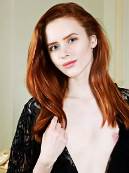 Spunky redhead removes black gown to unveil her smooth pussy and