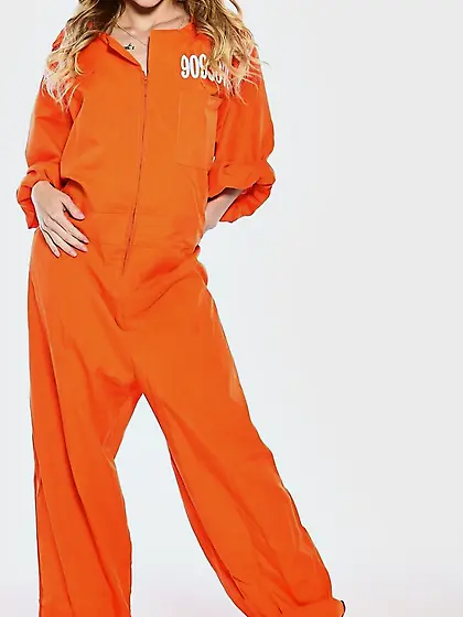 Female inmate in orange uniform flashes pierced nipple to seduce