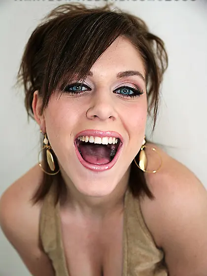 The charming doll Cameron Allure opens mouth showing the newly p