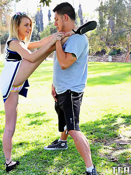 Horny cheerleader practicing stretches