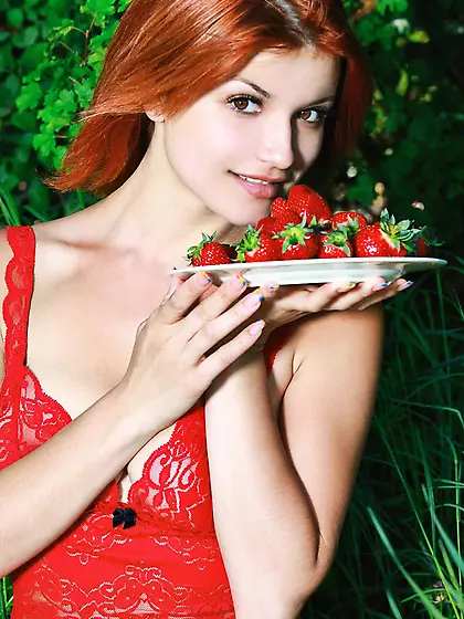 Sexy redhead chick Violla A takes off her red lingerie and poses