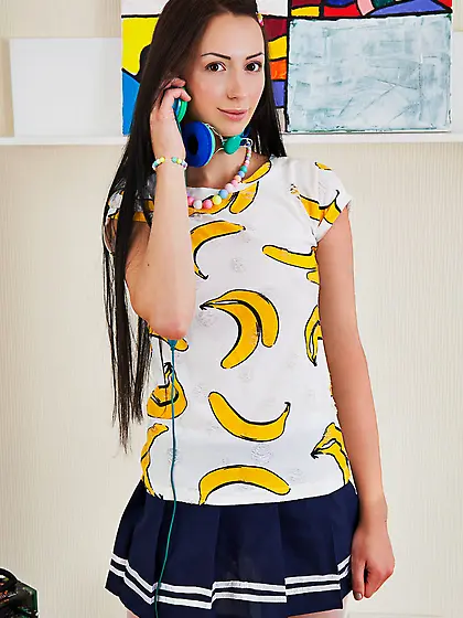 Skinny young girl removes skirt and pantyhose to model naked