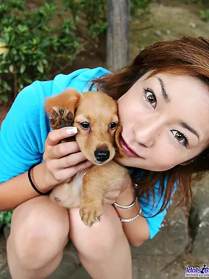 Posing with a dog is what one of the best Asian babes Nao Idols