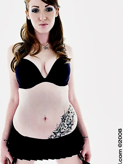 Alluring Nikki Rhodes in short skirt sticks index finger in her