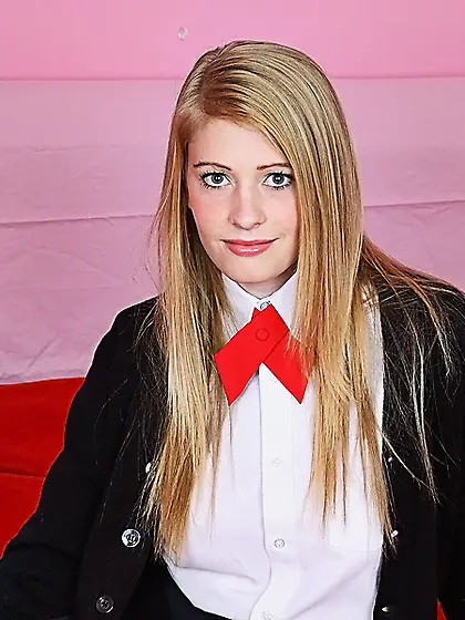 Provoking babe in a college uniform exposes boobs and pussy as w